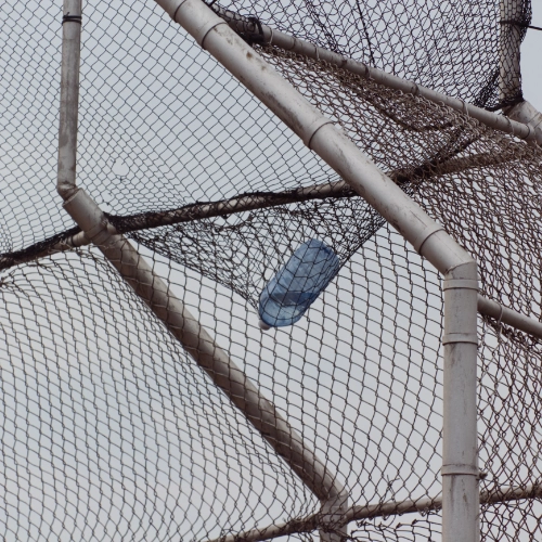 A large water bottle suspended from a net